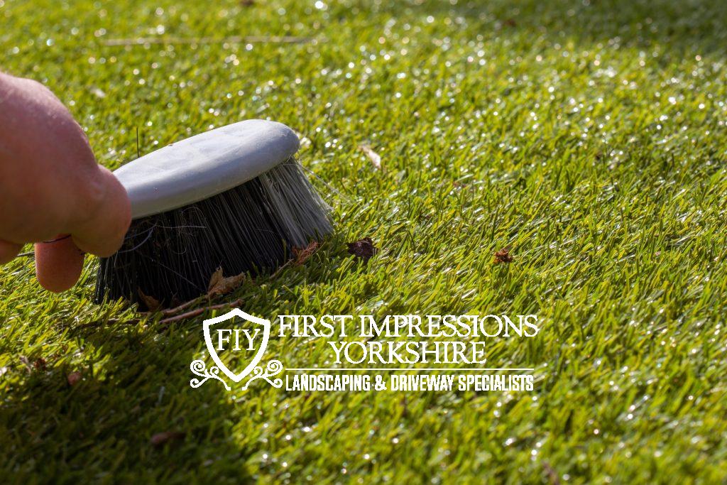 Brushing debris off of artificial grass