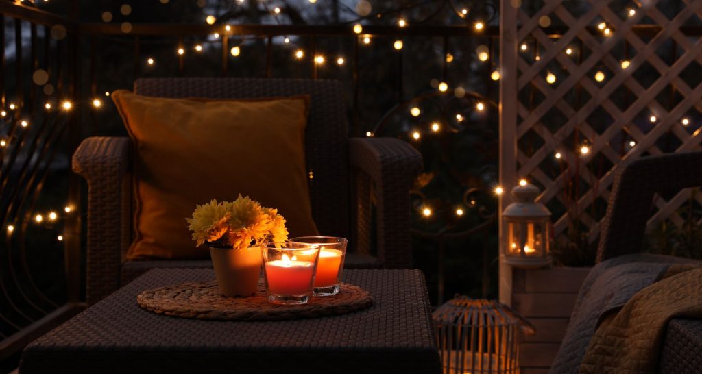 seated garden area with relaxing lights and candles on the outdoor table