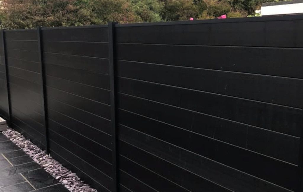 Black Composite fencing surrounding persons garden