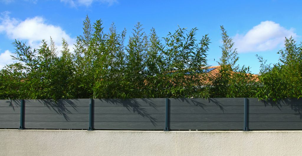 composite fencing on top of a garden wall